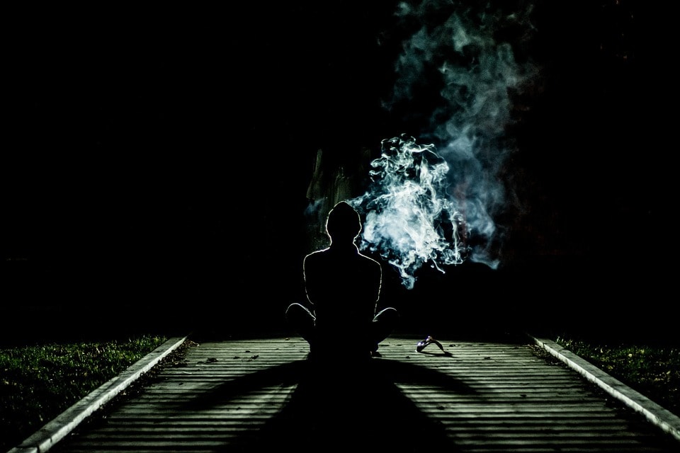 person meditating with a visible aura