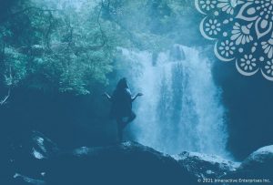 woman meditating in forest by a waterfall