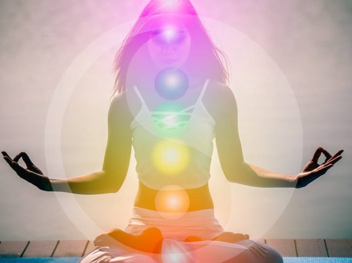woman meditating glowing 7 chakras
