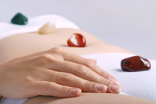 Alternative medicine - healing by semiprecious gems placed on body chakras, shallow depth of field