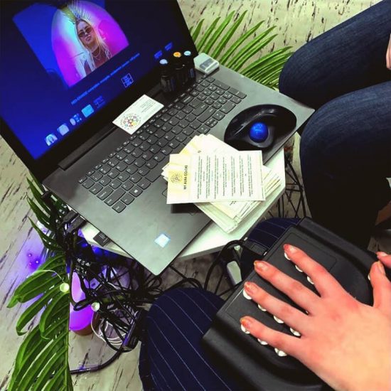 live photo of hand readings producing an aura reading on a laptop screen